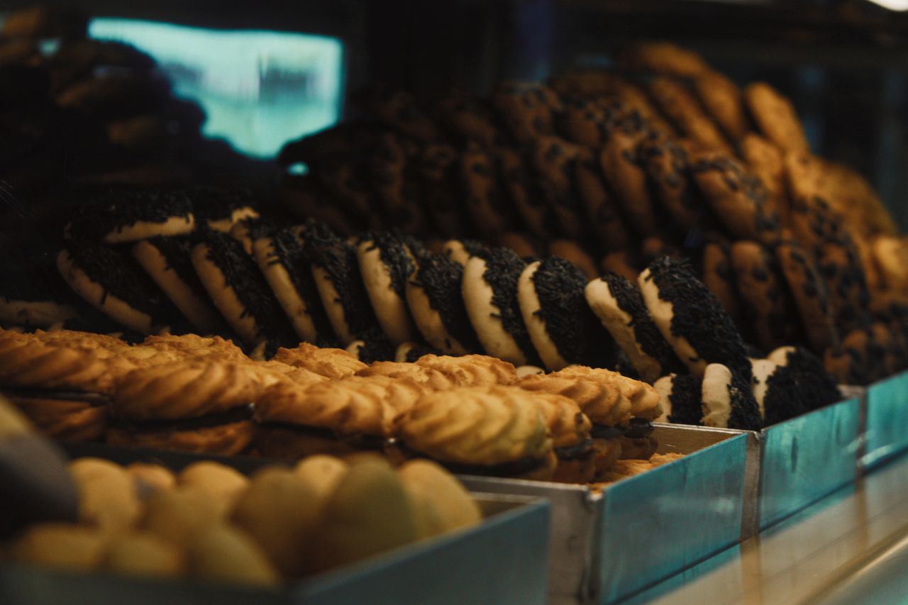 services-02 Delicious assortment of freshly baked cookies in a bakery display, showcasing variety and texture.