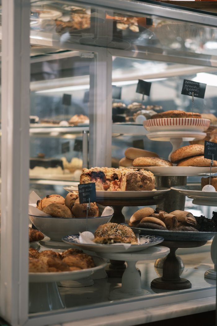 get-in-touch Assorted pastries and baked goods arranged in a charming glass cabinet for a mouthwatering showcase.