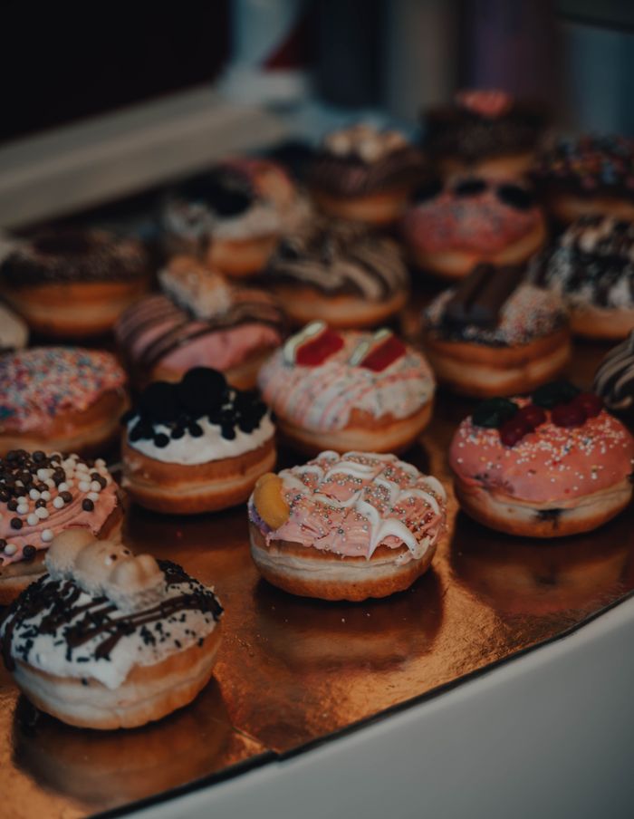 A vibrant display of assorted donuts with various toppings captured in a close-up shot.